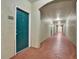 Apartment building hallway with green door and red floor at 1216 S Missouri S Ave # 222, Clearwater, FL 33756