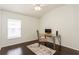 Home office space in a bedroom with a desk, chair, and dark hardwood floors at 1433 Emerald Hill Way, Valrico, FL 33594