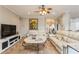 Spacious living room boasts comfortable seating, a large TV, and a marble-top coffee table at 1433 Emerald Hill Way, Valrico, FL 33594