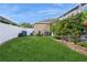 Large backyard with lush lawn, screened enclosure, and landscaping at 1433 Emerald Hill Way, Valrico, FL 33594