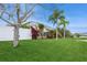 Landscaped backyard with tropical plants and screened enclosure at 1433 Emerald Hill Way, Valrico, FL 33594