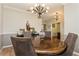 Elegant dining room with a round table and chandelier at 1433 Emerald Hill Way, Valrico, FL 33594