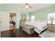 Spacious main bedroom with king-size bed, built-in storage, and access to the en-suite bathroom at 1433 Emerald Hill Way, Valrico, FL 33594