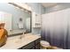 Clean bathroom with single sink vanity, shower/tub combo, and linen storage at 1433 Emerald Hill Way, Valrico, FL 33594
