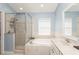 Elegant bathroom with a soaking tub, shower, and double sink vanity at 1433 Emerald Hill Way, Valrico, FL 33594
