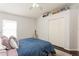 Cozy bedroom with a double bed, ample closet space, and dark hardwood floors at 1433 Emerald Hill Way, Valrico, FL 33594