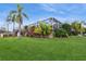 Expansive backyard with tropical plants and screened pool area at 1433 Emerald Hill Way, Valrico, FL 33594