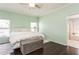 Serene main bedroom with a king-size bed, light walls, and dark hardwood floors at 1433 Emerald Hill Way, Valrico, FL 33594