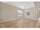 Bright dining room area featuring hardwood floors and a decorative chandelier at 16835 Hawkridge Rd, Lithia, FL 33547