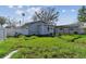 House with a large backyard, grassy area, and wooden arbor at 1757 New Hampshire Ne Ave, St Petersburg, FL 33703