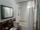 Bathroom with a shower/tub combo, toilet, and a new mirror at 1757 New Hampshire Ne Ave, St Petersburg, FL 33703