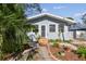 Newly painted light blue home with a walkway and landscaping at 1757 New Hampshire Ne Ave, St Petersburg, FL 33703