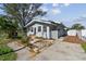 Charming bungalow with a newly painted exterior and a small front yard at 1757 New Hampshire Ne Ave, St Petersburg, FL 33703