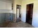 Unfinished laundry area with a water heater and exposed framing at 1757 New Hampshire Ne Ave, St Petersburg, FL 33703
