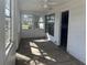 Bright sunroom with multiple windows and a ceiling fan at 1757 New Hampshire Ne Ave, St Petersburg, FL 33703