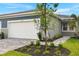 New home exterior with attached garage and landscaped walkway at 20351 Symphony Pl, Venice, FL 34293