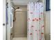 Walk-in shower with a flamingo shower curtain at 2227 Willowbrook Dr, Clearwater, FL 33764