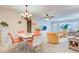 Bright dining area with a white table and orange chairs at 2450 Canadian Way # 6, Clearwater, FL 33763