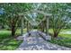 Covered walkway with a pergola and lush landscaping at 2450 Canadian Way # 6, Clearwater, FL 33763