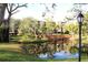 Serene pond reflecting the community buildings at 3076 Eastland Blvd # 106, Clearwater, FL 33761