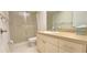 Bathroom featuring a shower with glass doors, toilet and a vanity sink at 3076 Eastland Blvd # 106, Clearwater, FL 33761
