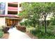 Inviting building entrance with well-maintained landscaping and visible unit number at 3076 Eastland Blvd # 106, Clearwater, FL 33761