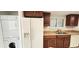 Well-equipped kitchen with stainless sink, dishwasher and a white fridge and laundry machines at 3076 Eastland Blvd # 106, Clearwater, FL 33761