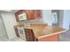Open kitchen features wooden cabinets and countertops and a white oven at 3076 Eastland Blvd # 106, Clearwater, FL 33761