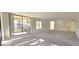 Spacious living room with sliding glass doors to a balcony and carpeted floors at 3076 Eastland Blvd # 106, Clearwater, FL 33761