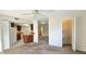 Bright living room view to the kitchen and the closet area with shelves at 3076 Eastland Blvd # 106, Clearwater, FL 33761