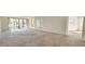 Spacious living room with neutral carpet and sliding glass doors to balcony at 3076 Eastland Blvd # 106, Clearwater, FL 33761