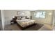 Comfortable bedroom with neutral decor, large window, and modern furnishings at 3076 Eastland Blvd # 106, Clearwater, FL 33761