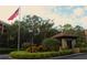 Gated community entrance with guardhouse and landscaping at 3076 Eastland Blvd # 106, Clearwater, FL 33761