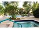 Community hot tub with surrounding lounge chairs at 3076 Eastland Blvd # 106, Clearwater, FL 33761