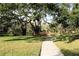 Peaceful walkway with lush landscaping and pond at 3076 Eastland Blvd # 106, Clearwater, FL 33761