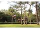 Landscaped grounds with a gated entrance and flag at 3076 Eastland Blvd # 106, Clearwater, FL 33761