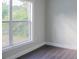 Bright bedroom with large window and dark hardwood floors at 3623 N 52Nd St, Tampa, FL 33619