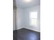 Cozy bedroom with large window and dark hardwood floors at 3623 N 52Nd St, Tampa, FL 33619