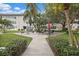 Community courtyard with seating and tropical landscaping at 5720 13Th N Ave # 203B, St Petersburg, FL 33710