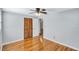 Bedroom with hardwood floors, ceiling fan, and built-in closet at 5814 S 6Th St, Tampa, FL 33611