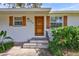 Inviting front entrance with a rustic wood door and stone steps at 5814 S 6Th St, Tampa, FL 33611