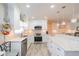 Updated kitchen featuring white cabinets, stainless steel appliances, and granite countertops at 606 Ojai Ave, Sun City Center, FL 33573