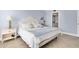 Light and airy bedroom with a king-size bed and ensuite bathroom access at 9000 Commodore Dr # 401, Seminole, FL 33776