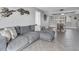 Spacious living area featuring a large sectional sofa and herringbone-patterned floors at 9000 Commodore Dr # 401, Seminole, FL 33776