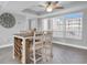 Bright dining area with a unique table and chairs, and a large clock on the wall at 9000 Commodore Dr # 401, Seminole, FL 33776