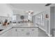 Modern kitchen with white cabinets, marble countertops and stainless steel appliances at 9000 Commodore Dr # 401, Seminole, FL 33776