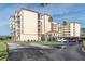 Three-story building with covered parking and landscaping at 9000 Commodore Dr # 401, Seminole, FL 33776
