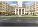 Exterior view of a multi-story building with parking and an entrance at 9000 Commodore Dr # 401, Seminole, FL 33776