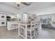 Open concept dining area with a kitchen view and a contemporary table set at 9000 Commodore Dr # 401, Seminole, FL 33776
