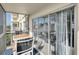 Screened balcony with outdoor furniture and partial water view at 9000 Commodore Dr # 401, Seminole, FL 33776